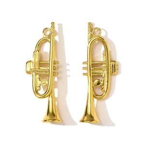 Detailopname van kleine gouden trompet hangers met gepolijste afwerking en fijne details