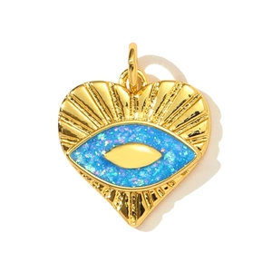 Golden heart-shaped Evil Eye pendant with blue opal-like glitter and radial patterns