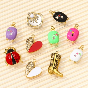 Detailed collection of assorted enamel charms including ladybug, boots and suitcases