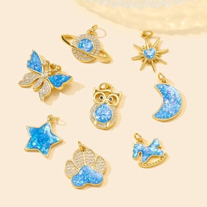 Golden moon and star pendants set with blue fire opal and shimmering zirconias