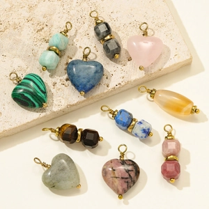 Natural heart and cylinder stone pendants with gold wire wrapping on stone board