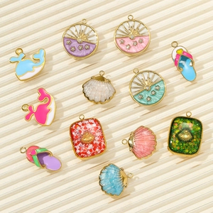 Macro shot of summer ocean theme DIY charms with whale, shell, and flip-flop pendants