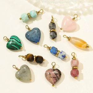 Selection of diverse natural stone heart and bead pendants with gold wire wrapping