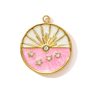 Detailed close-up of a round gold pendant with sunburst enamel and sparkling star crystals