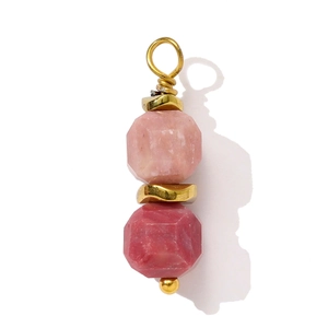 Detail of pink natural stone pendant with faceted quartz and golden metal spacers