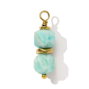 Macro shot of handmade light blue amazonite gemstone pendant with gold wire wrapping detail
