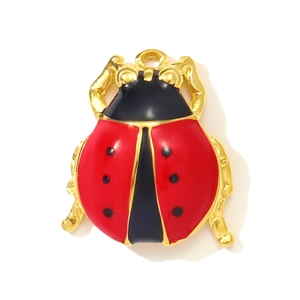 Detailed macro view of a red and black ladybug pendant with golden metal edges