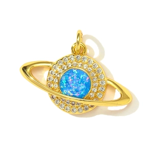 Detailed close-up of a gold-plated Saturn pendant with blue opal and white cubic zirconia