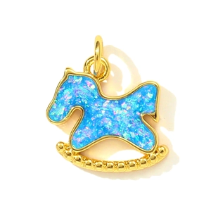 Detailed close-up of a rocking horse pendant featuring blue opal and golden metal frame