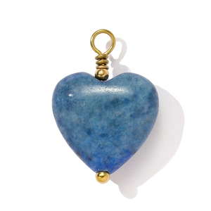 Macro detail of heart-shaped blue natural stone pendant with gold wire wrapping