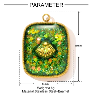 Detail view of a 19mm gold stainless steel shell pendant with green glitter enamel inlay