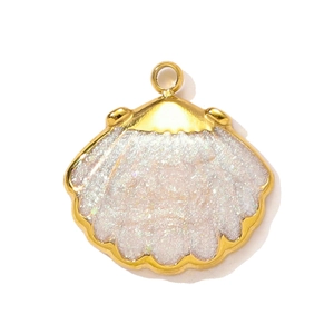 Macro shot of shell shaped gold stainless steel pendant for jewelry making