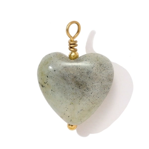 Detail of heart-shaped natural stone pendant with gold wire wrapping and polished finish