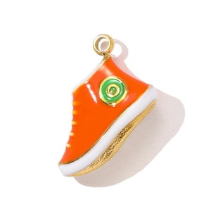 Detailed macro view of orange sneaker pendant with gold plating and enamel finish