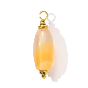 Detail of oval orange carnelian gemstone pendant with handmade gold wire wrap
