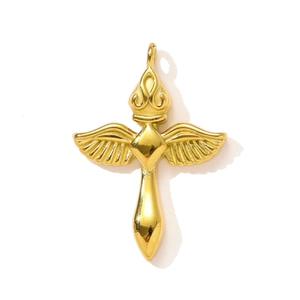 Vue macro d'un pendentif croix dorée avec ailes détaillées et sommet en couronne polie
