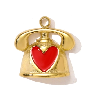 Detail of vintage gold telephone pendant with red heart enamel for DIY jewelry making