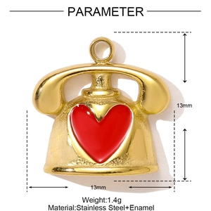 Macro detail of vintage gold telephone pendant with red heart and 13mm dimensions