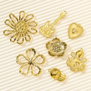 Detailed collection of gold pendants featuring floral, heart, and octopus designs for DIY