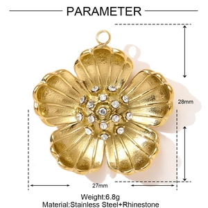 Detailed view of golden flower pendant with white rhinestones and size measurements