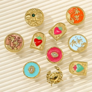 Detail of ten colorful enamel brooches with palm tree, shell, and ocean-themed motifs