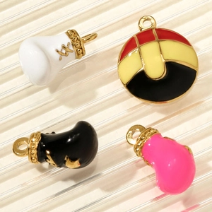 Detailed macro view of colorful boxing glove pendants and round enamel charms for DIY jewelry