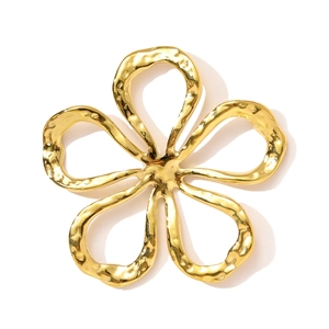 Detail of gold flower pendant with hammered texture finish and vintage aesthetic
