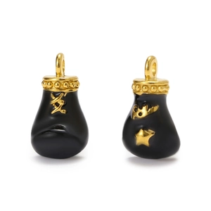 Detailed view of black enamel boxing glove pendants with gold moon and star accents