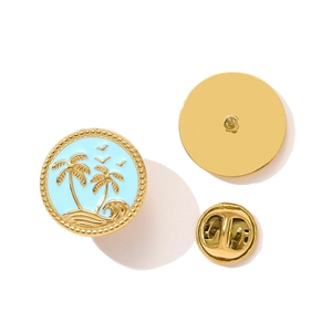 Detail of round gold enamel brooch with blue tropical island coconut tree relief