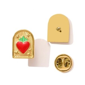 Macro view of sacred heart enamel brooch with red heart, gold stars, and metal butterfly clutch
