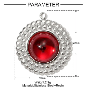 Detail view of round stainless steel pendant with red resin bead and 22mm height dimension