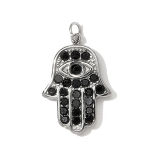 Detailed view of silver Hamsa Hand pendant with micro-pave black gemstones and eye design