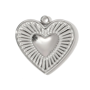 Close-up of heart-shaped stainless steel pendant with radial sunburst texture details