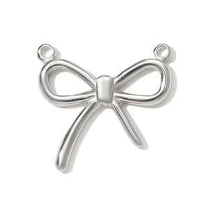 Close-up of polished stainless steel bow charm with double rings for jewelry making