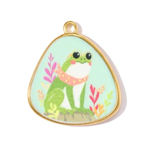 Detail shot of a triangle stainless steel frog pendant with a gold-tone metal frame