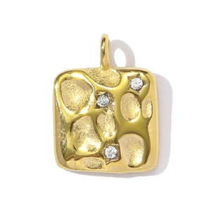 Detail of square gold pendant with molten texture and three starburst-set zircons