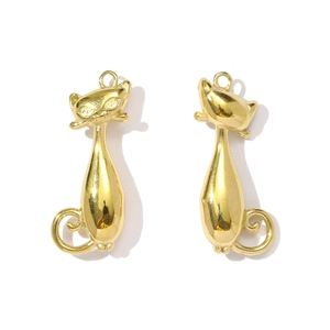 Detail of gold-plated cat pendants featuring a minimalist feline shape and polished finish