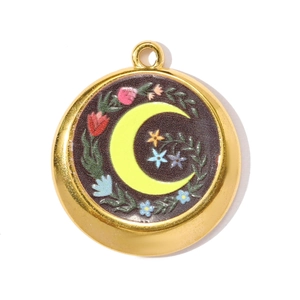 Detail of round stainless steel pendant with yellow crescent moon and colorful floral enamel
