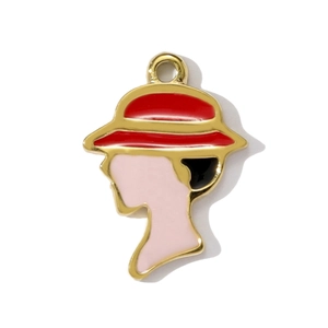 Detail of a fashion female silhouette pendant with red hat and gold-plated drip oil finish