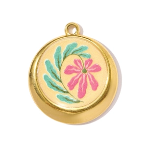 Detail of round gold-plated pendant featuring pink floral hand-painted enamel and green leaves