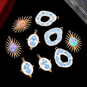 Vintage blue and white porcelain pendants in sunflower and vase shapes on black velvet