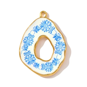 Detail of sunflower pendant with blue floral porcelain pattern and gold metal frame