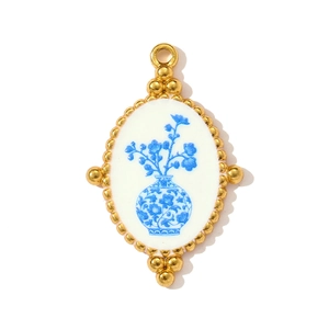 Detailed macro view of vintage gold sunflower pendant with blue and white porcelain pattern