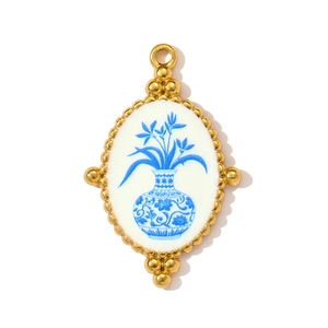 Detail of vintage Chinese blue and white porcelain pattern on a gold stainless steel pendant