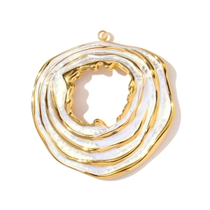 Detailed view of large gold-plated stainless steel flower pendant with white enamel inlay
