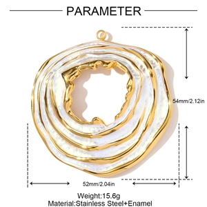 Macro shot of large golden stainless steel pendant with white enamel and wavy texture