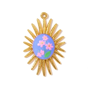 Macro detail of sunflower pendant with blue floral patterns and hammered gold texture