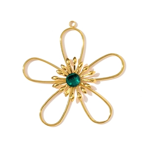 Detail of a gold flower pendant with hollow petals and a faceted green gemstone center