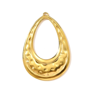 Macro view of gold teardrop hollow pendant with hammered metal texture for necklaces
