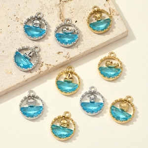 Nautical theme ocean charms with blue resin inlay and sea creature motifs in gold and silver